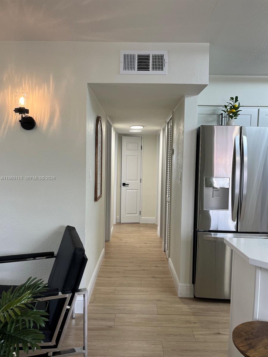 2253 Dordon Drive Melbourne, FL 32935 - Photo 23 of 40 a view of a livingroom with furniture and a refrigerator