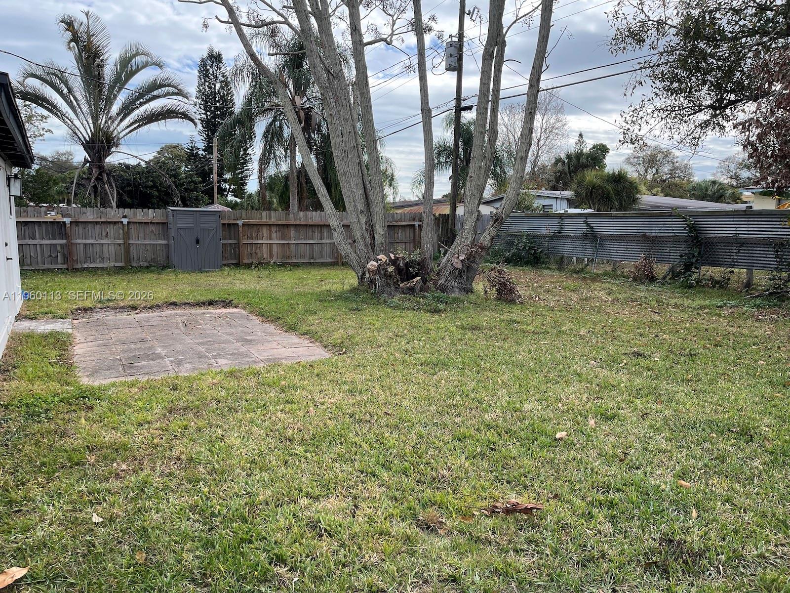 2253 Dordon Drive Melbourne, FL 32935 - Photo 36 of 40 a view of backyard with wooden fence and a large tree