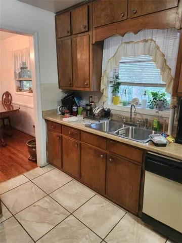 a kitchen with stainless steel appliances a sink a stove and a microwave