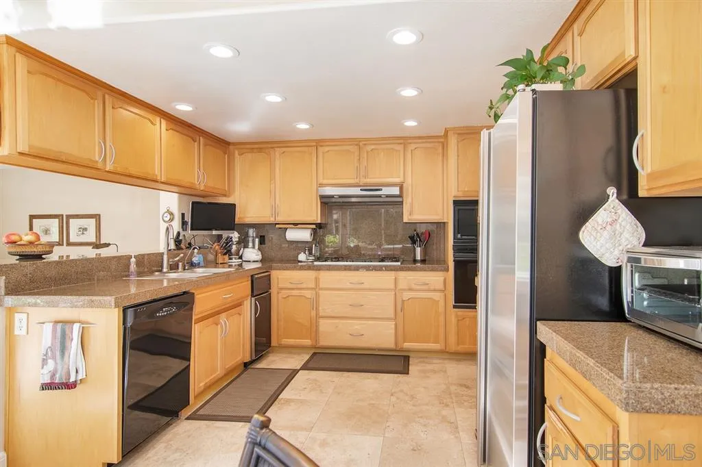 13861 Carriage Road Poway, CA 92064 - Photo 8 of 25 a kitchen with stainless steel appliances granite countertop a refrigerator sink and cabinets