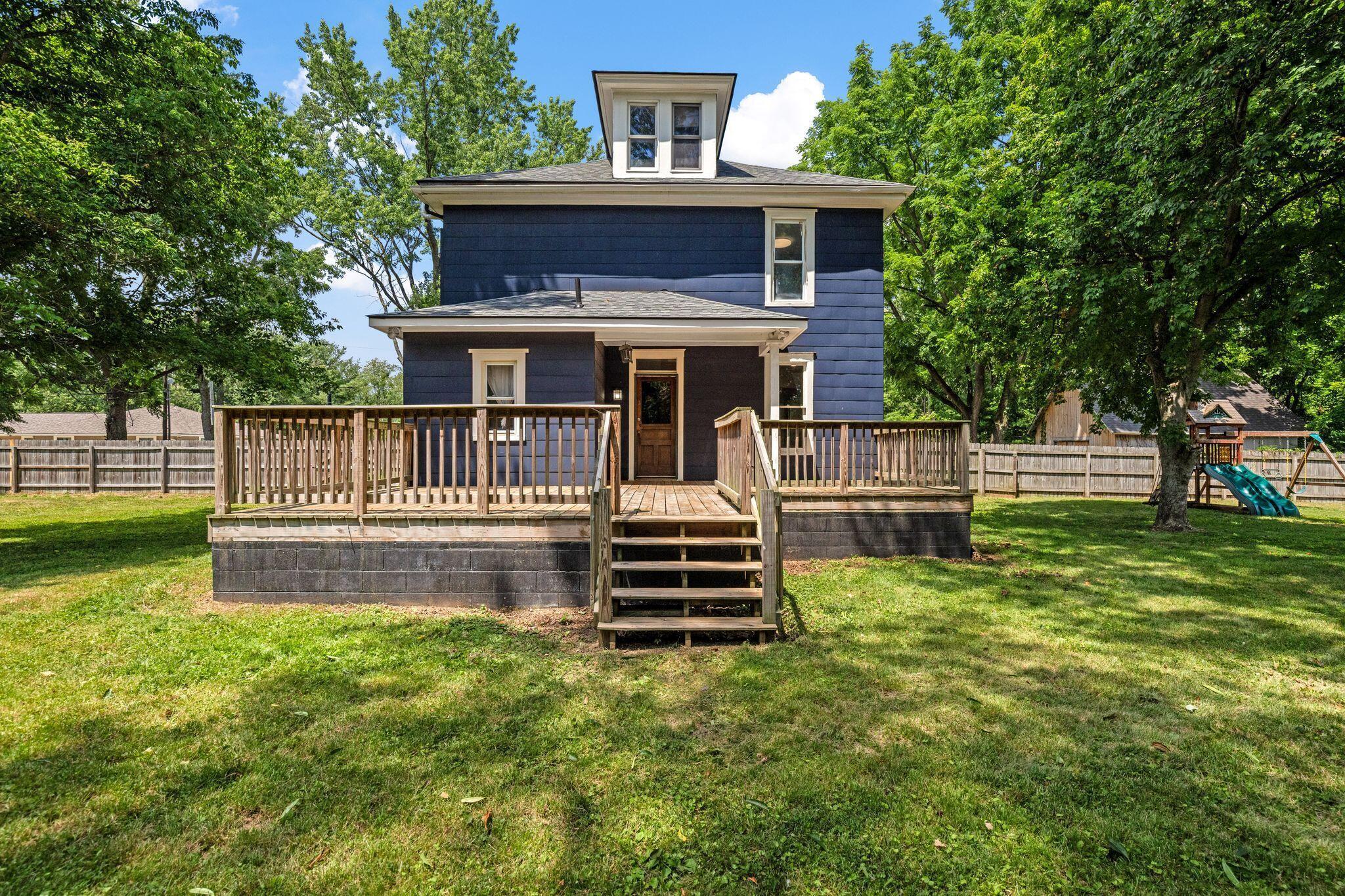107 Price Road Columbus, OH 43230 - Photo 38 of 51 Rear exterior featuring a spacious wooden deck with railings and steps to the yard
