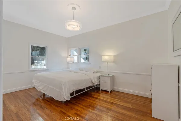 a bedroom with a bed and a night stand