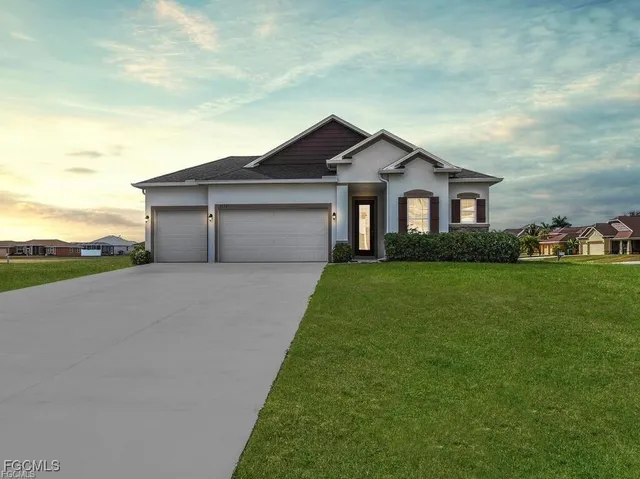 a front view of a house with a yard and garage