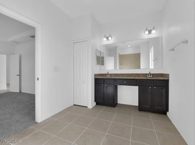 a kitchen with a sink a counter top space and cabinets