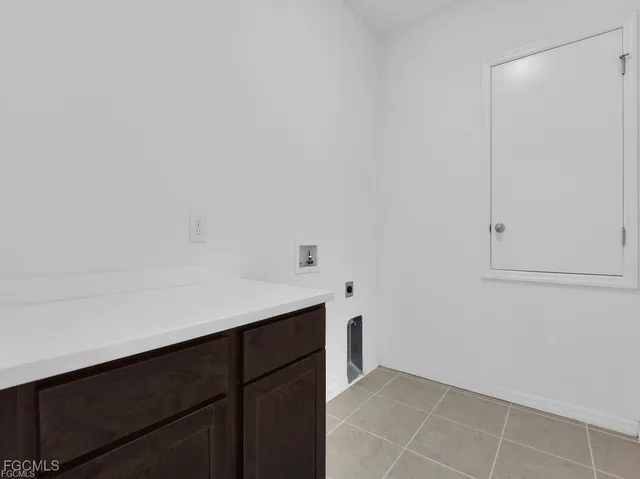 a kitchen with a sink cabinets and utility room