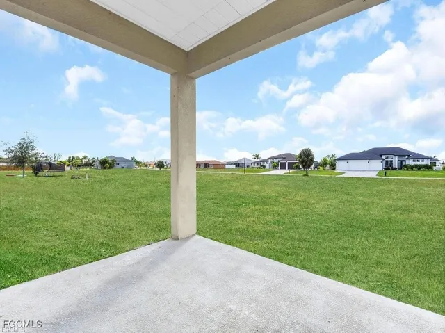a view of a garden with a building in the background