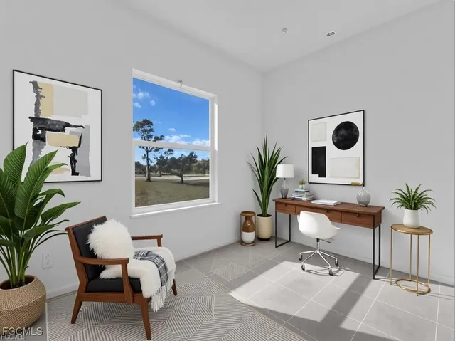 a living room with furniture and a potted plant