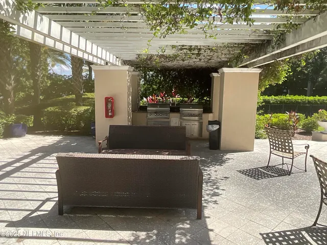 a view of a patio with table and chairs and potted plants