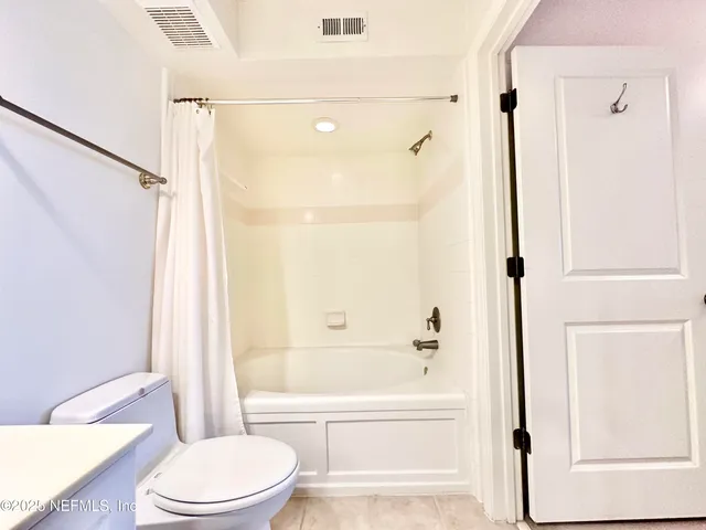 a bathroom with a bathtub toilet and shower