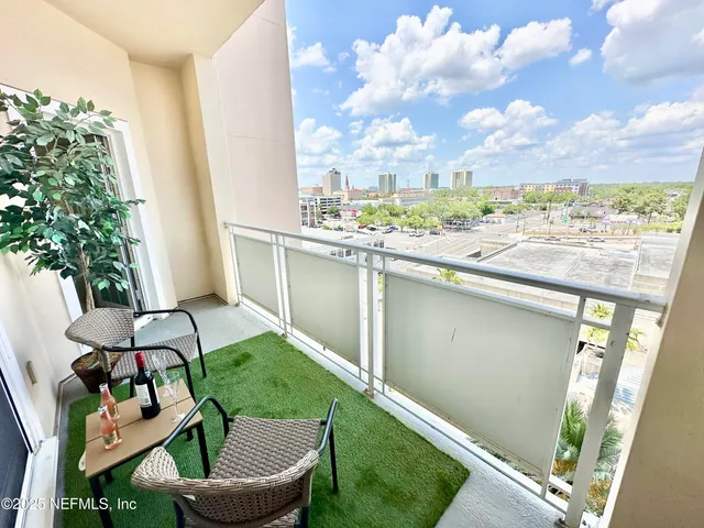 a view of a chair and tables in the balcony