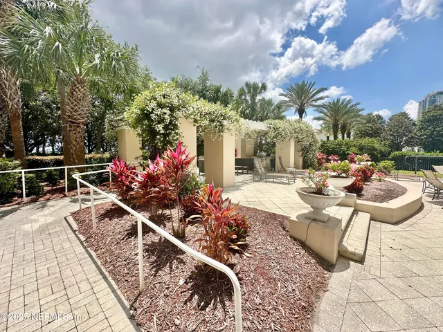 a view of a patio with couches table and chairs and potted plants