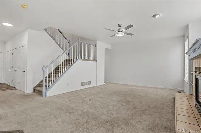 en view interior of a house with stairs and a ceiling fan
