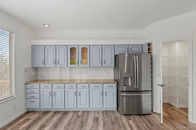 a kitchen with kitchen island wooden cabinets and stainless steel appliances