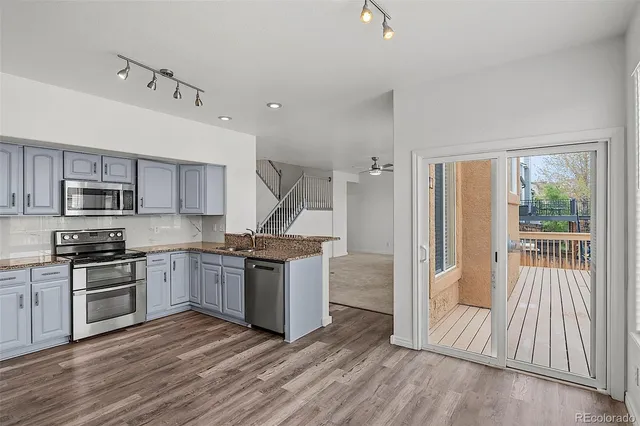 a kitchen with stainless steel appliances granite countertop a stove top oven and sink