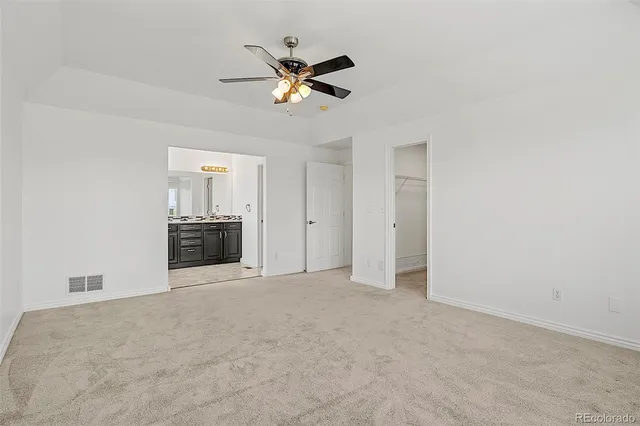 a view of a livingroom with a ceiling fan and entryway