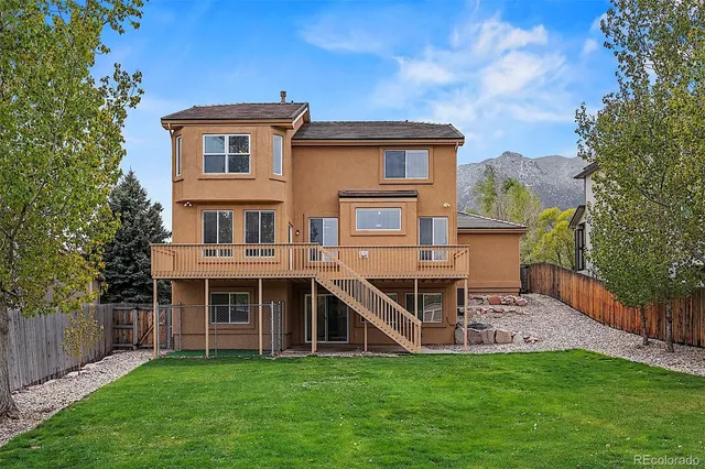 a view of a house with a yard and sitting area