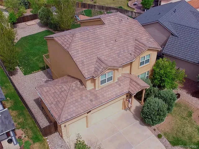 an aerial view of a house with a yard