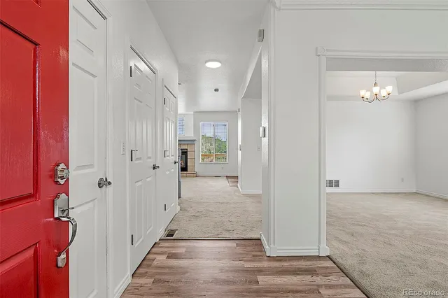 a view of a hallway with wooden floor and staircase