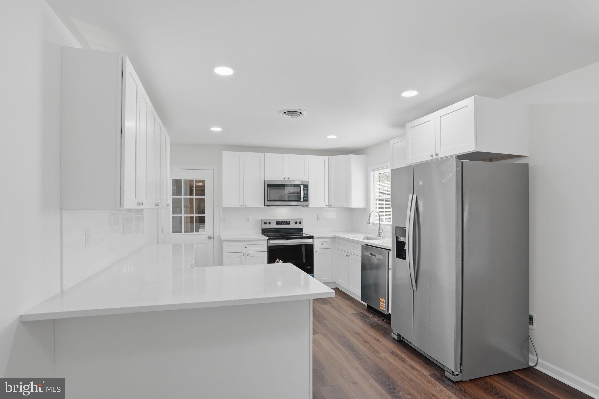 1804 Hourglass Road Hartly, DE 19953 - Photo 16 of 46 a kitchen with refrigerator a stove and a refrigerator