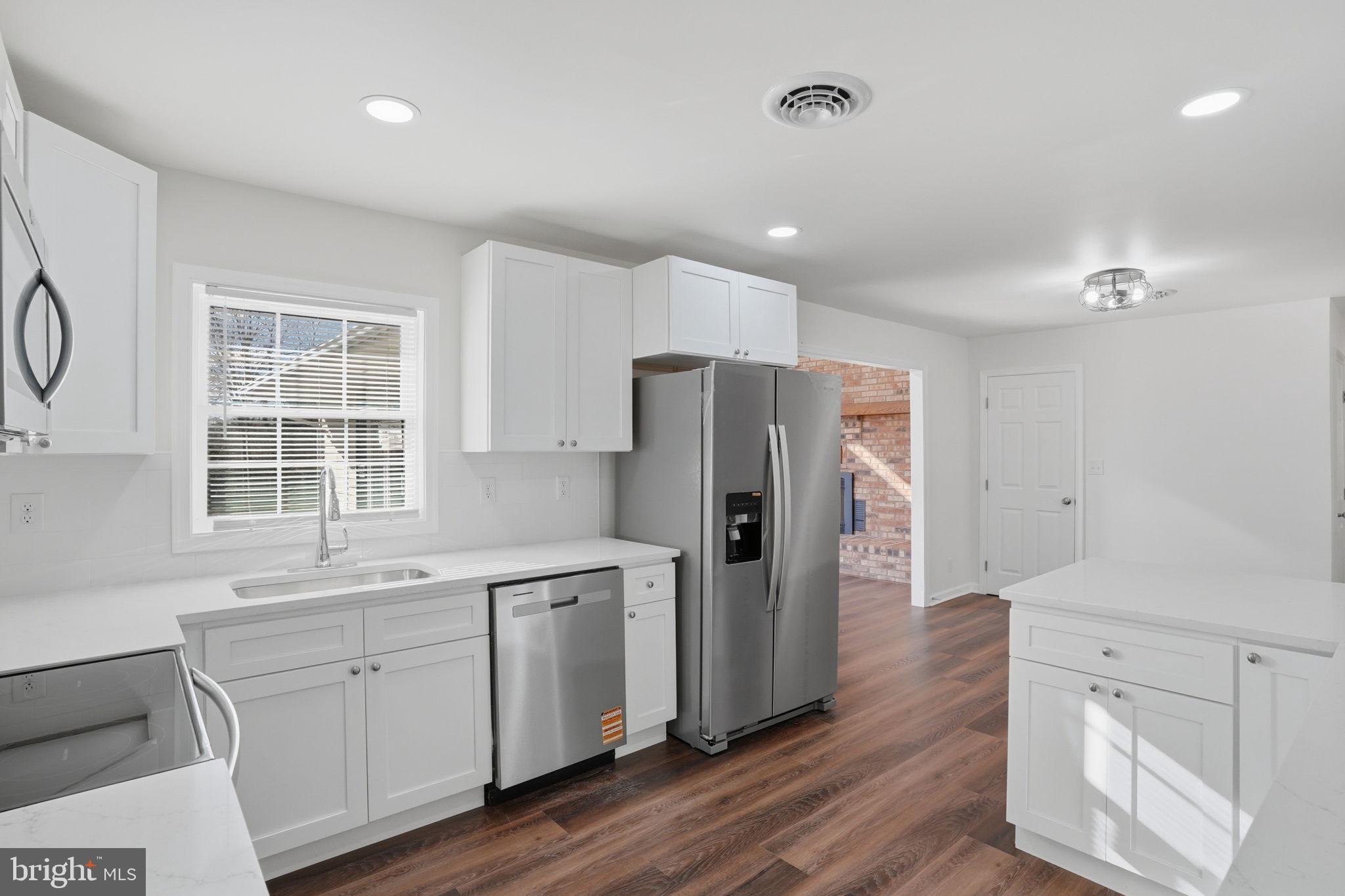 1804 Hourglass Road Hartly, DE 19953 - Photo 17 of 46 a kitchen with white cabinets and refrigerator