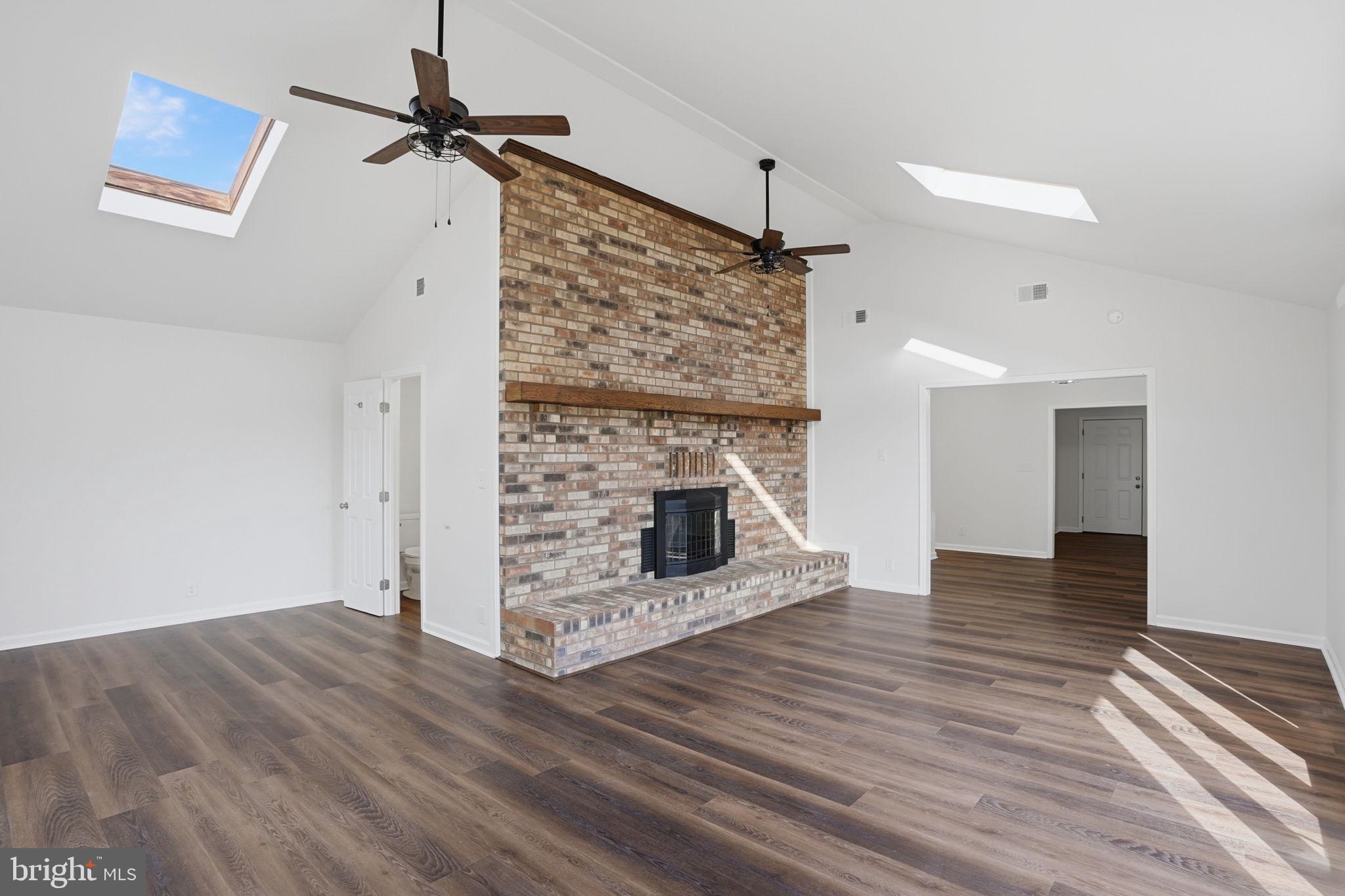 1804 Hourglass Road Hartly, DE 19953 - Photo 18 of 46 a view of a livingroom with wooden floor a fireplace and window