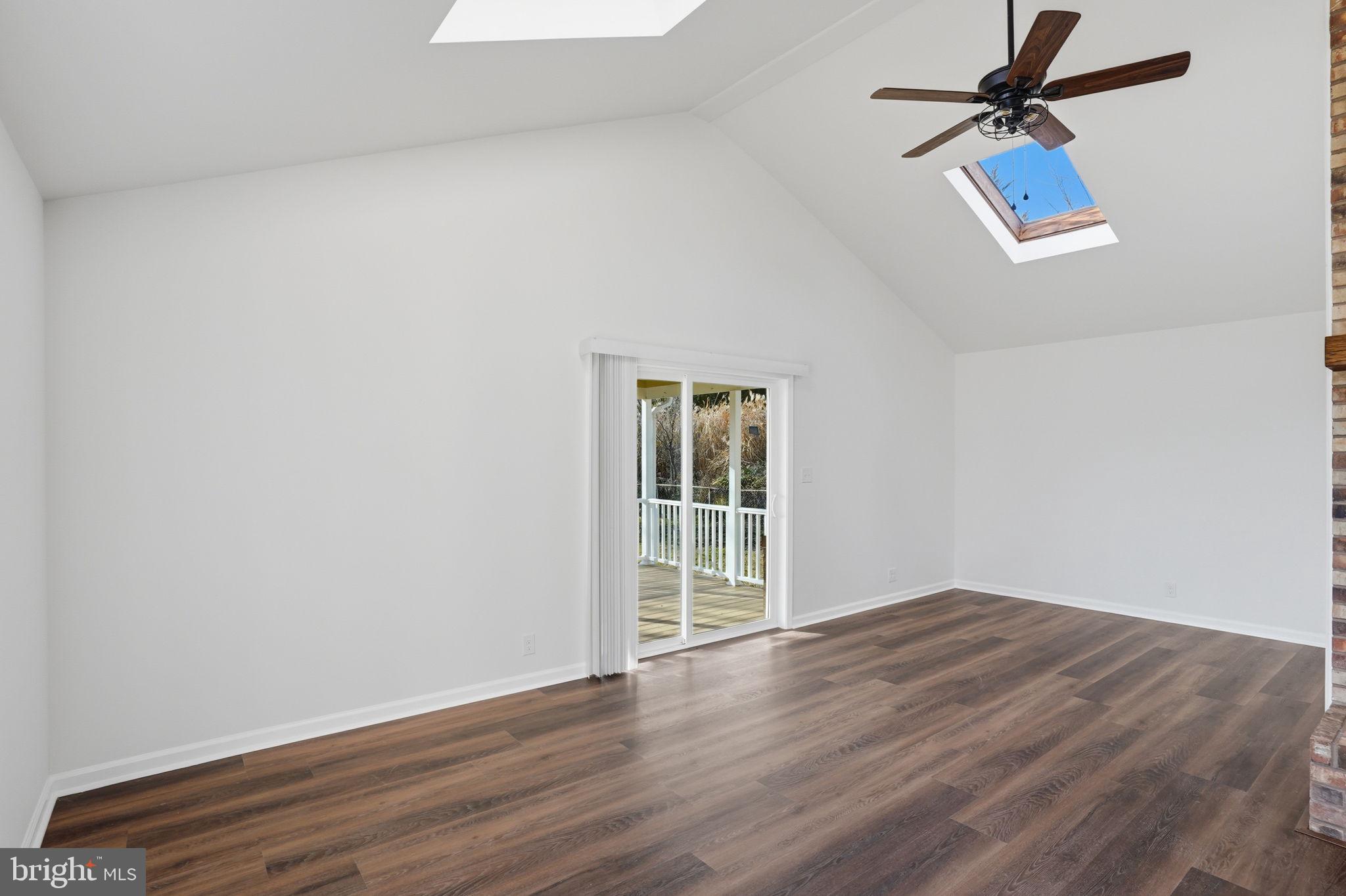 1804 Hourglass Road Hartly, DE 19953 - Photo 20 of 46 an empty room with wooden floor ceiling fan and windows