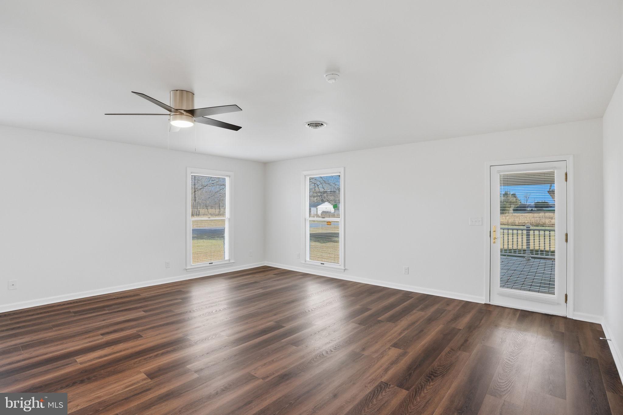1804 Hourglass Road Hartly, DE 19953 - Photo 24 of 46 a view of an empty room with wooden floor and a window