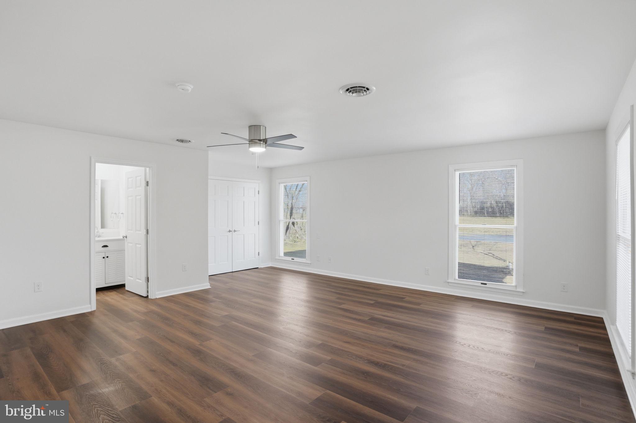 1804 Hourglass Road Hartly, DE 19953 - Photo 26 of 46 a view of an empty room with wooden floor and a window