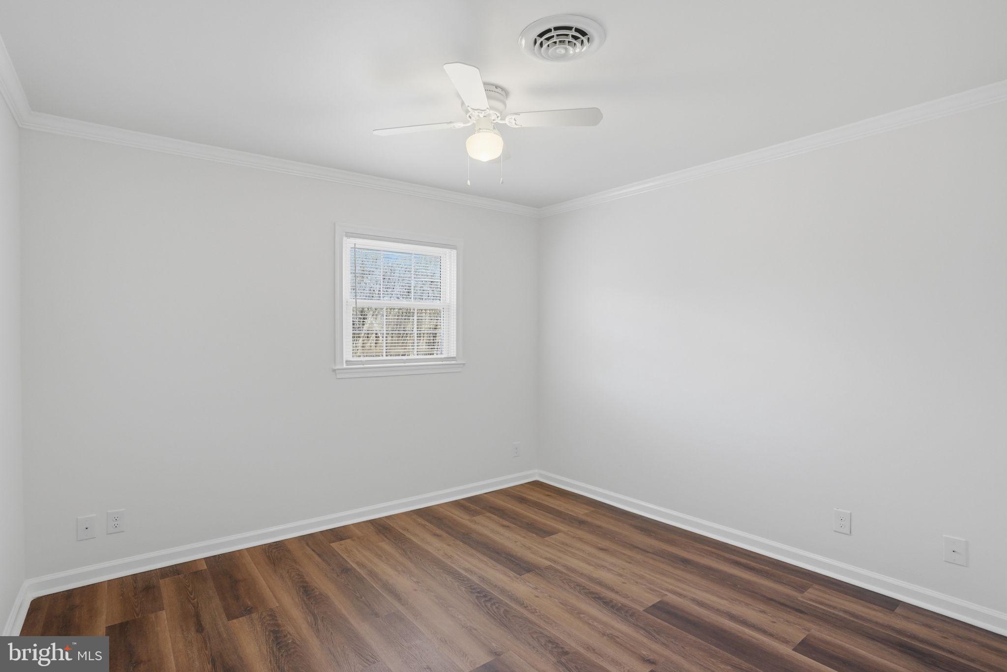 1804 Hourglass Road Hartly, DE 19953 - Photo 28 of 46 an empty room with wooden floor and windows