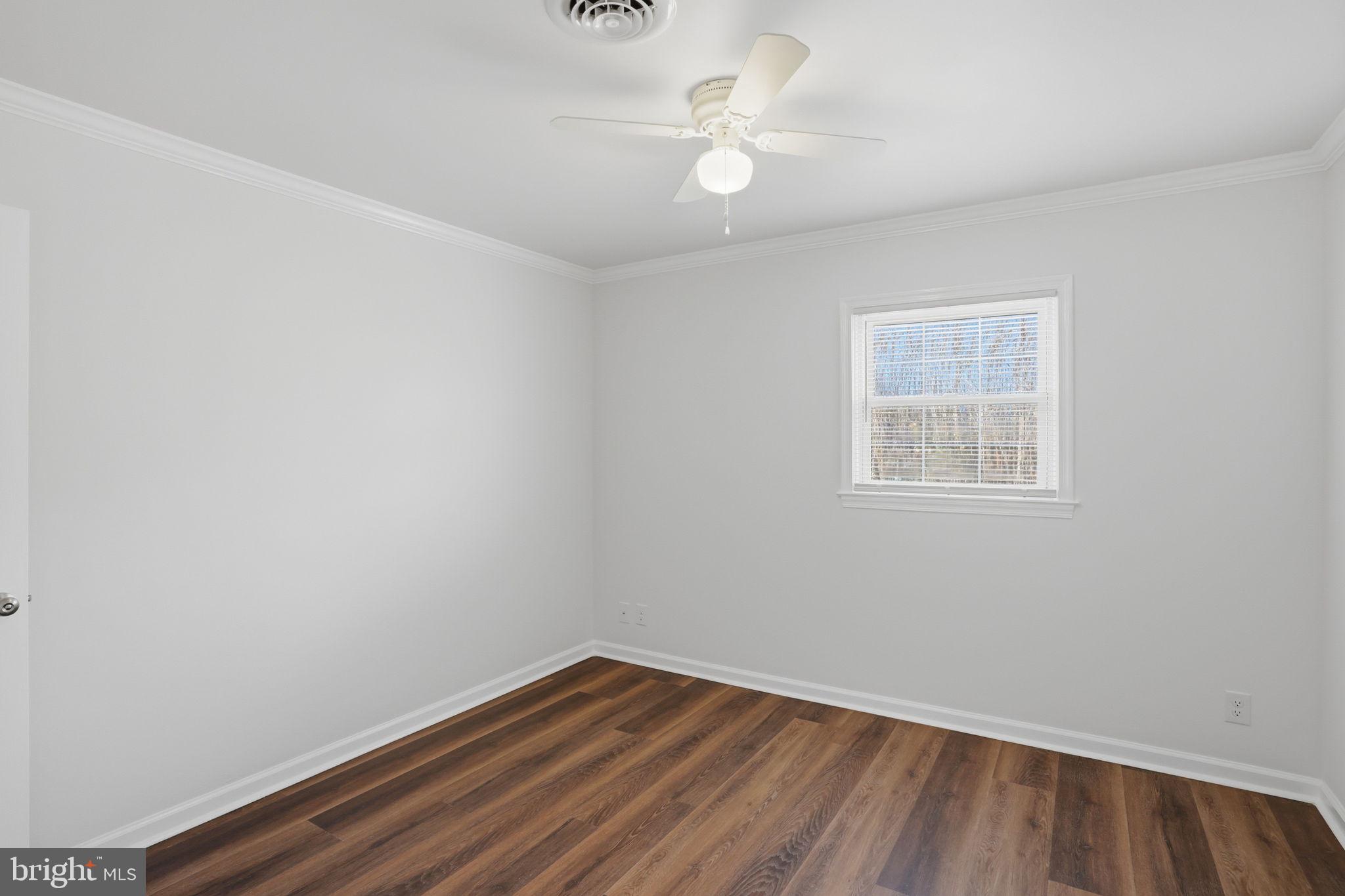 1804 Hourglass Road Hartly, DE 19953 - Photo 29 of 46 an empty room with wooden floor and window