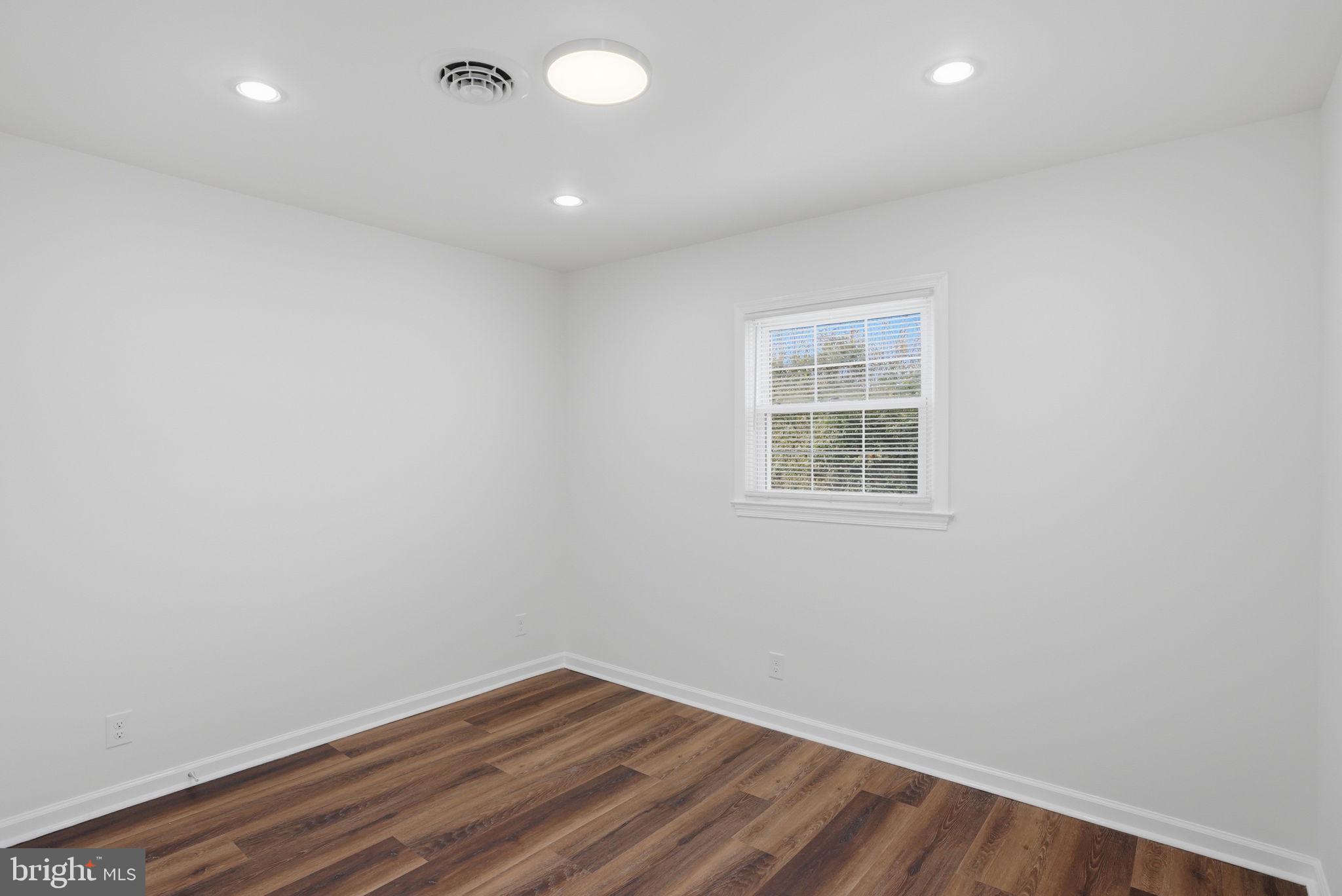 1804 Hourglass Road Hartly, DE 19953 - Photo 30 of 46 an empty room with wooden floor and windows