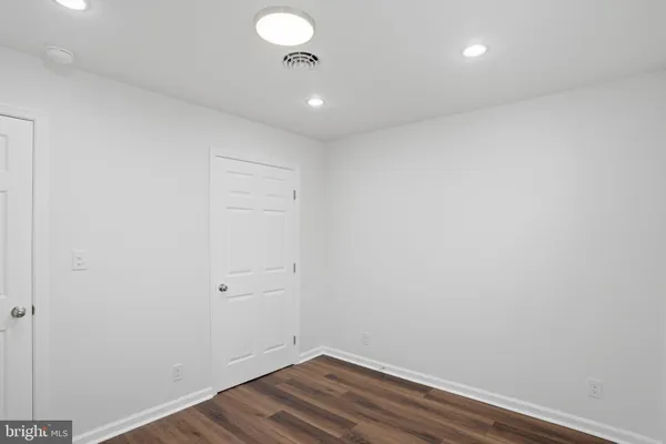 a view of room with wooden floor