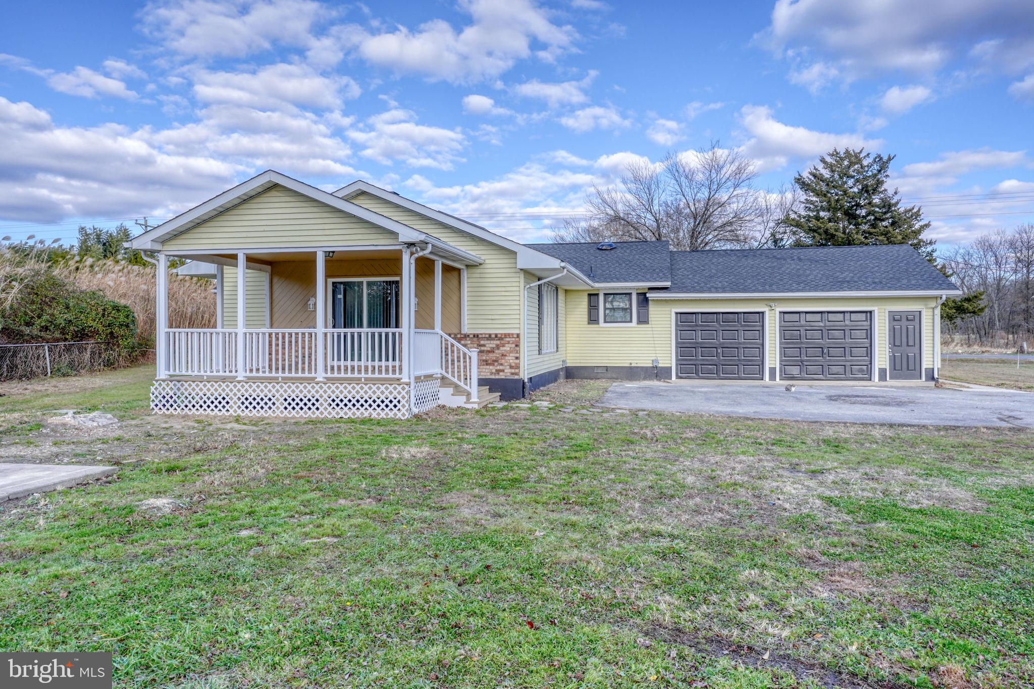 1804 Hourglass Road Hartly, DE 19953 - Photo 40 of 46 a front view of a house with a yard and garage
