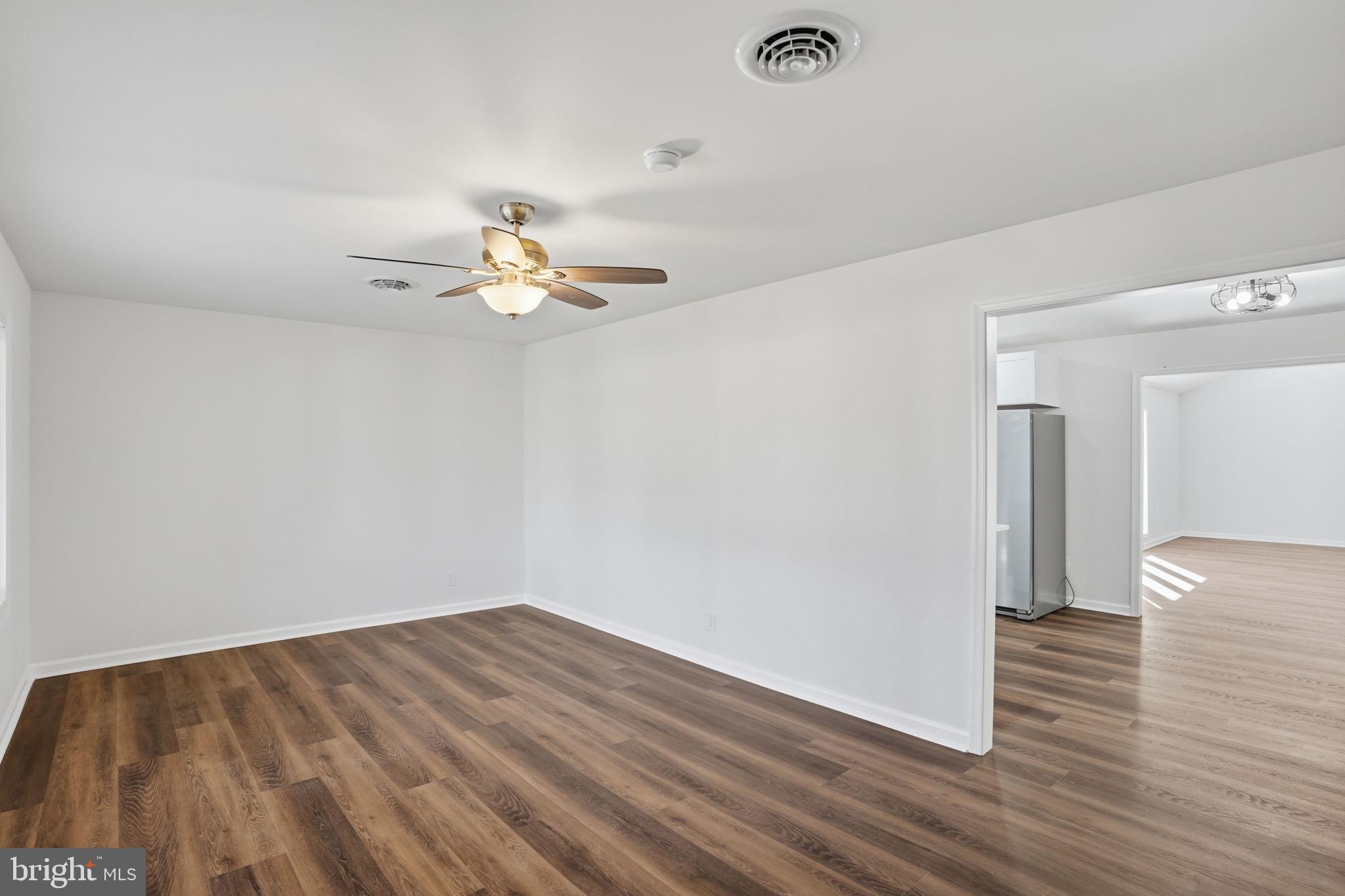 1804 Hourglass Road Hartly, DE 19953 - Photo 9 of 46 a view of a room with wooden floor and a ceiling fan