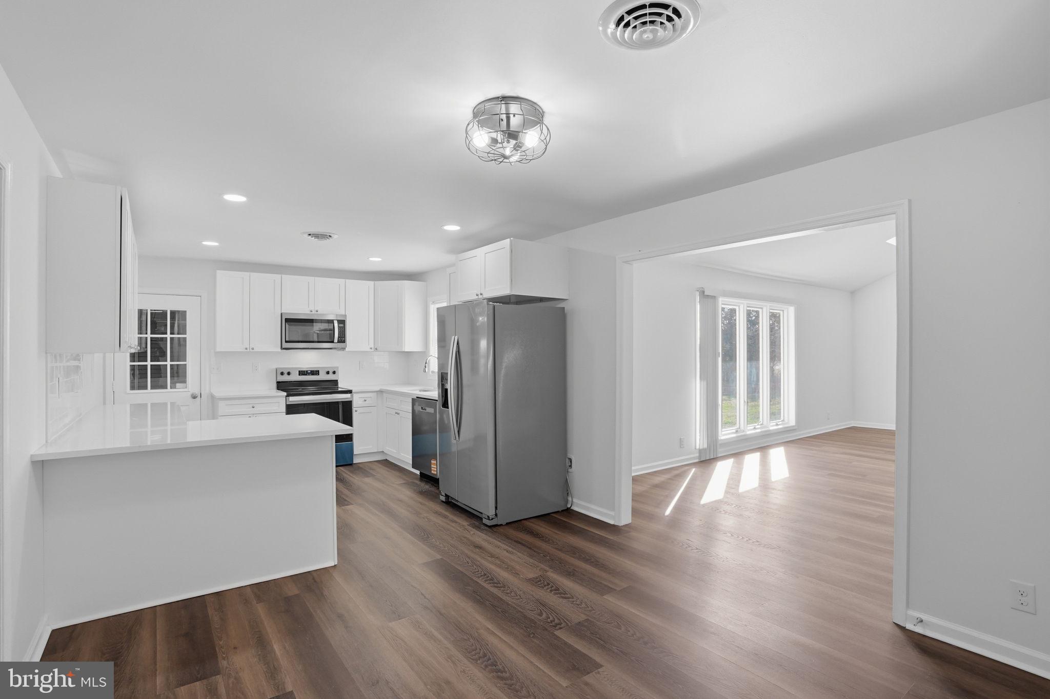 1804 Hourglass Road Hartly, DE 19953 - Photo 10 of 46 a kitchen with stainless steel appliances a refrigerator and a stove top oven
