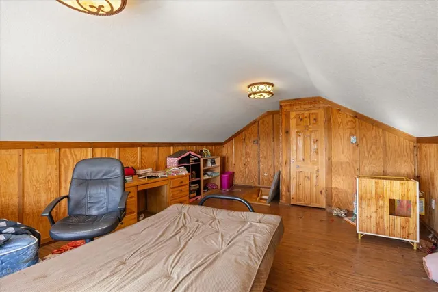 a bed room with a bed and a chair