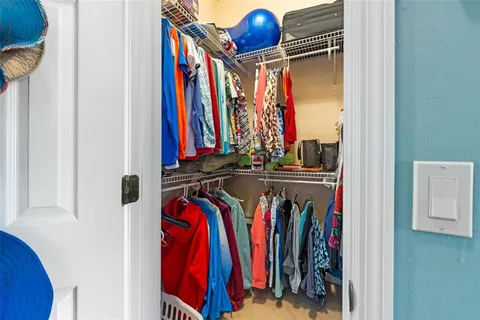 a view of walk in closet with clothes