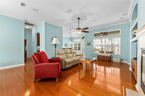 a living room with furniture and wooden floor