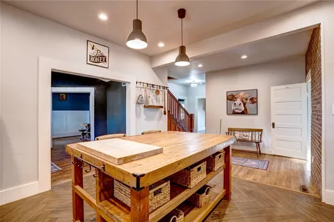 a kitchen with a stove a refrigerator and a table
