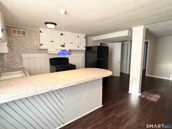 a kitchen with stainless steel appliances a refrigerator sink and cabinets