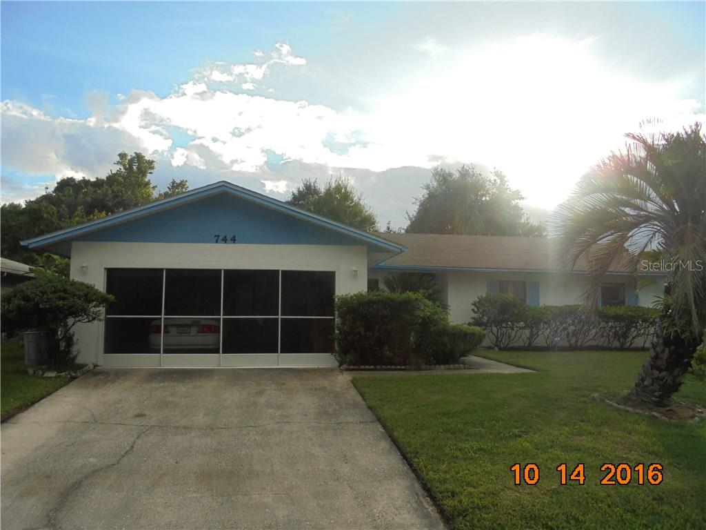 744 Del Rio Way Kissimmee, FL 34758 - Photo 1 of 1 front view of a house with a garden