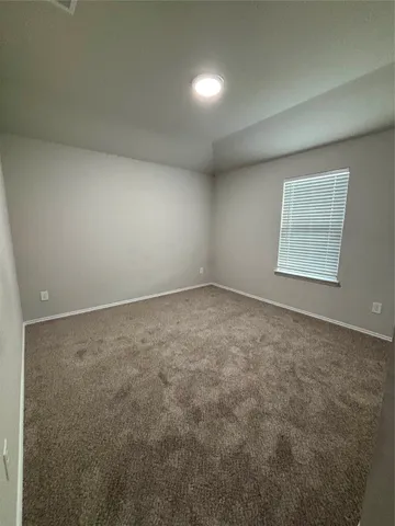 an empty room with a empty space and windows