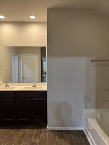 a bathroom with a bathtub and a sink