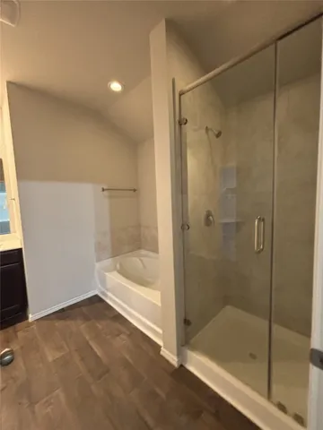 a bathroom with a bathtub and a shower