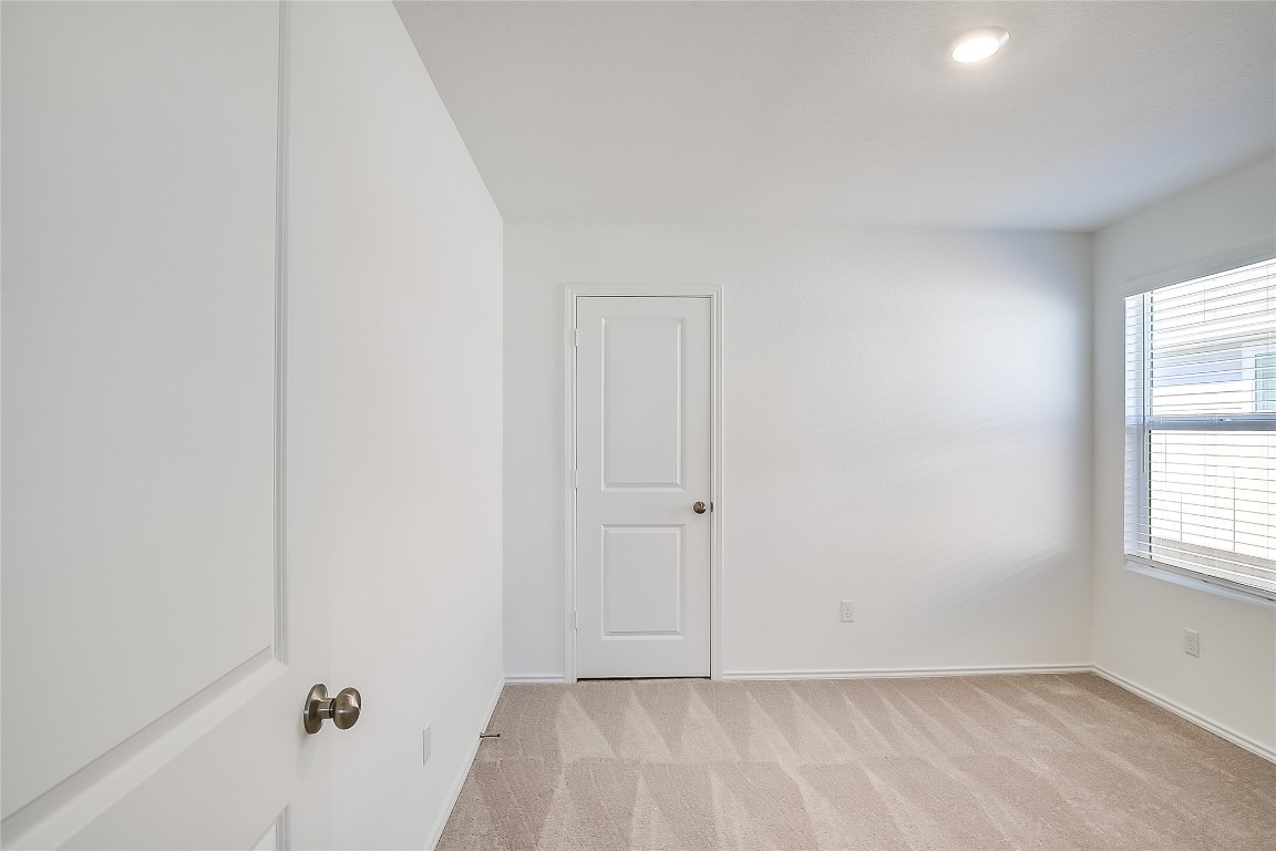 1133 Largemouth Road Bastrop, TX 78602 - Photo 12 of 16 an empty room with a window