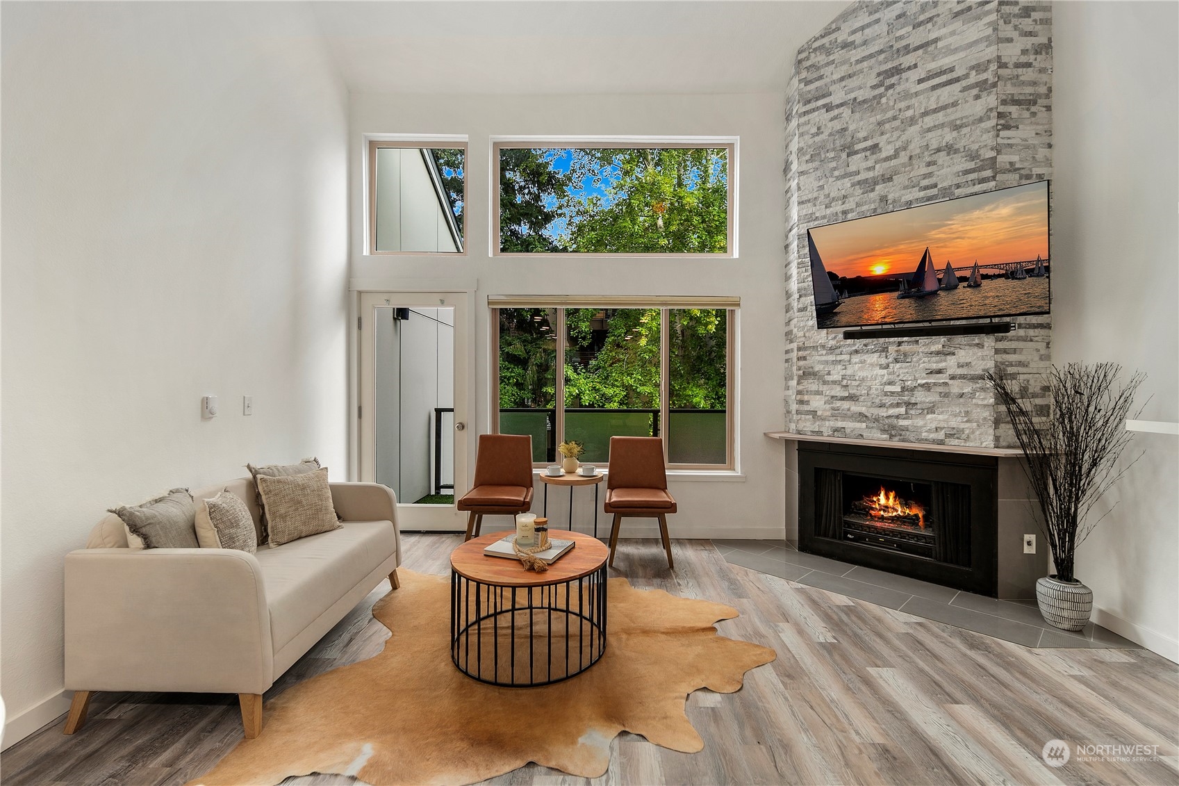 7307 Sand Point Way Northeast, Unit B618 Seattle, WA 98115 - Photo 12 of 23 a living room with furniture a flat screen tv and a fireplace