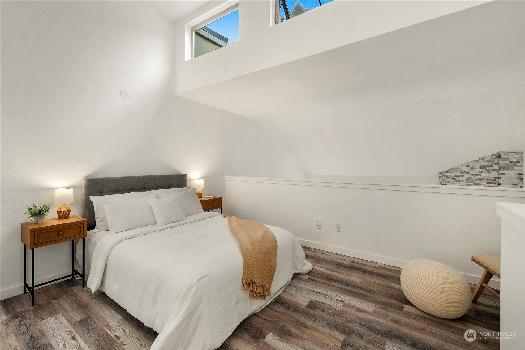 7307 Sand Point Way Northeast, Unit B618 Seattle, WA 98115 - Photo 16 of 23 a bedroom with a bed and wooden floor