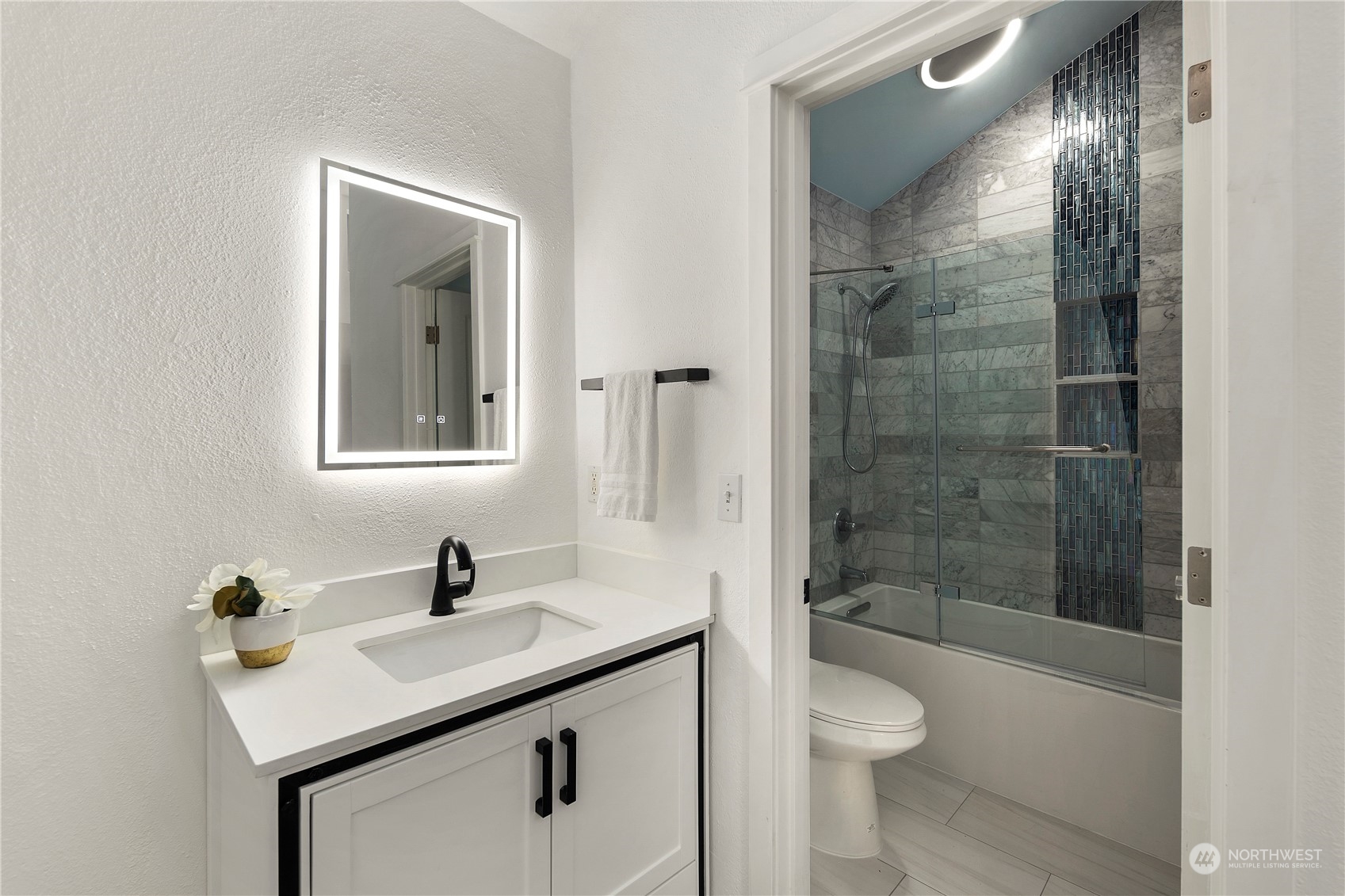 7307 Sand Point Way Northeast, Unit B618 Seattle, WA 98115 - Photo 20 of 23 a bathroom with a sink toilet a shower and a mirror