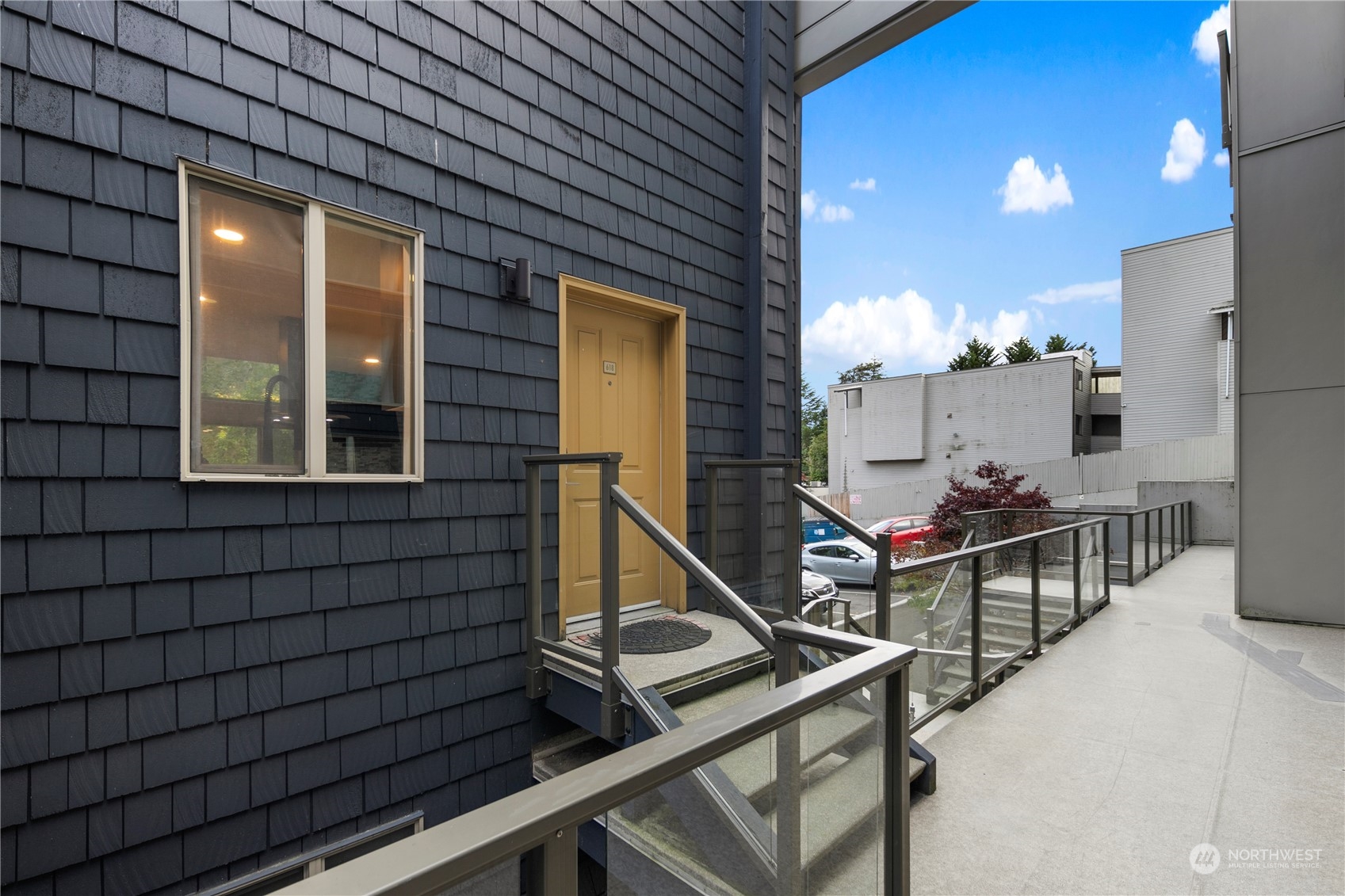 7307 Sand Point Way Northeast, Unit B618 Seattle, WA 98115 - Photo 2 of 23 a view of house with chairs and wooden fence