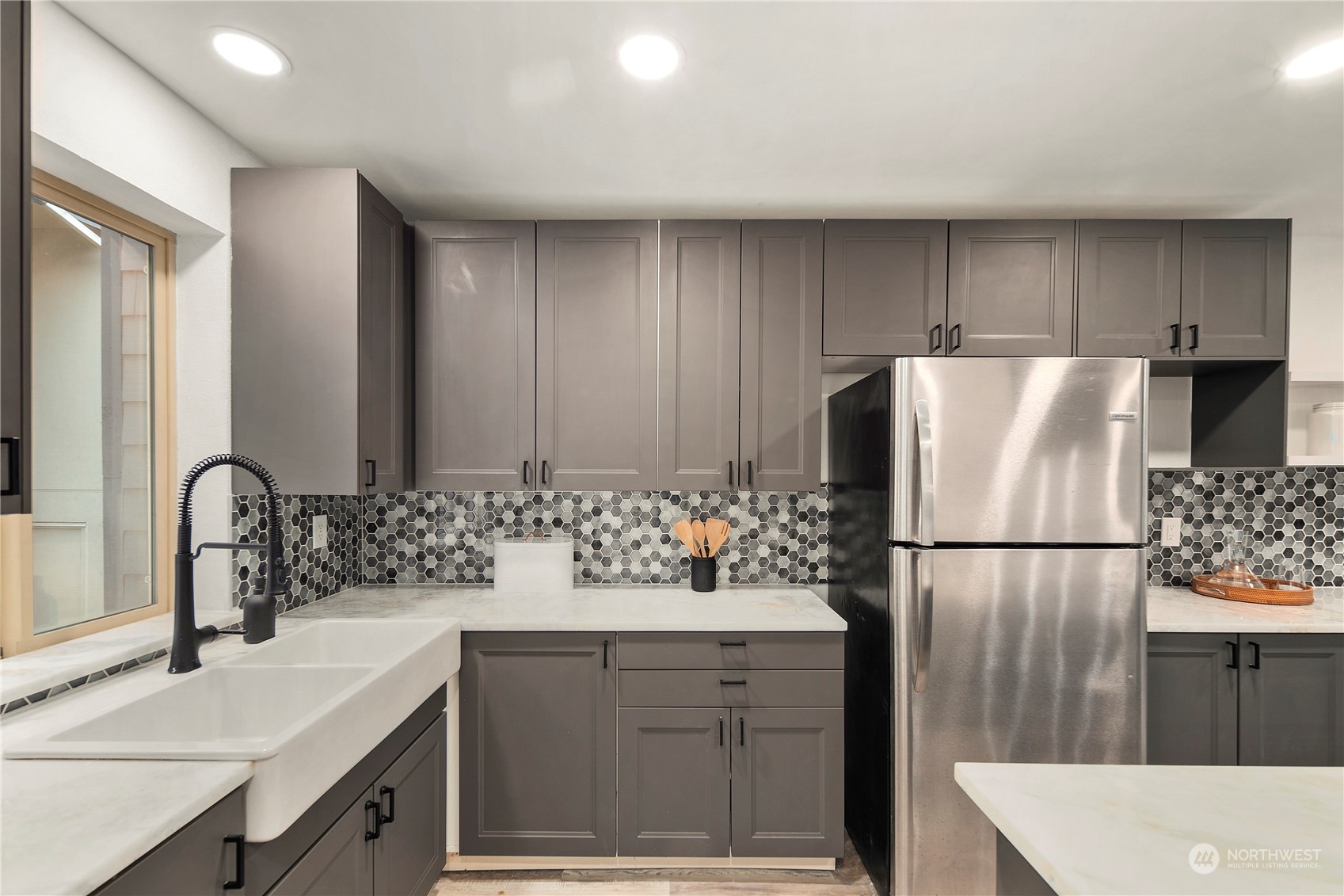 7307 Sand Point Way Northeast, Unit B618 Seattle, WA 98115 - Photo 8 of 23 a kitchen with a sink refrigerator and cabinets